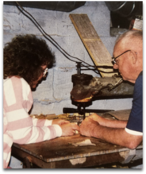 Faline with her grandfather, Rudy Mullet, cutting on the bandsaw he built from scratch.