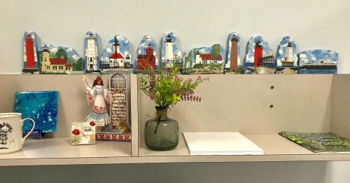Sandy's display of the Cat's Meow Village Michigan lighthouses on top of her work desk at  her workplace!