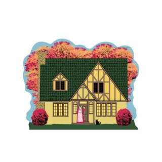 3/4" thick wooden Illustration of a yellow house with a woman and cat in front, surrounded by autumn trees.