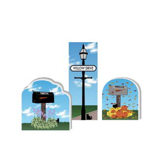 wooden replica Street sign on a lamppost with 'Willow Drive' text against a blue sky.