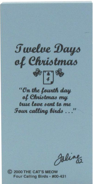 A light blue back of wooden replica with black text reading 'Twelve Days of Christmas' and a quote about four calling birds, plus a signature and copyright text for The Cat's Meow.