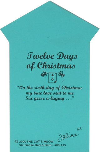A turquoise house with black printed text reading 'Twelve Days of Christmas' and a quote, plus small decorative graphics, photographed against a white background.