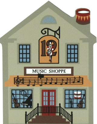 3/4" thick wooden replica of a music shop facade with the text 'MUSIC SHOPPE,' a large '12' above the door, musical notes across the balcony, instruments in the windows, and a drum on the roof.