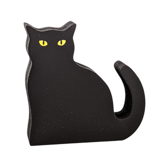 3/4" thick wooden Black cat-shaped object held in a hand against a white background