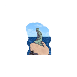 3/4" thick wooden replica with an illustration of  the Statue of Liberty sitting on a rock with the ocean and blue sky in the background, shown on a plain white background.