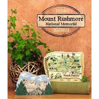 Mount Rushmore National Memorial 3/4" thick wooden cutout decor with a map of South Dakota on a wooden surface.