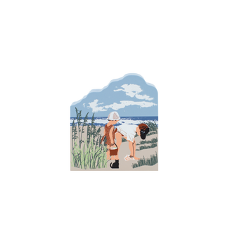 wooden replica with an Illustration of two children at the beach with a scenic background