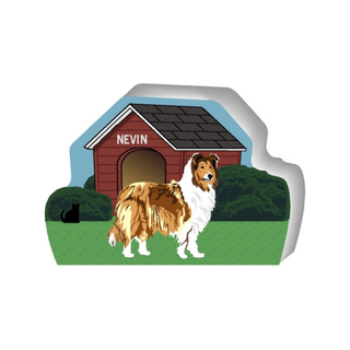 wooden replica of a illustrated brown and white collie dog standing in front of a dog house