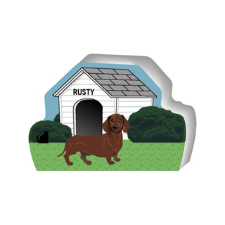 wooden replica of a illustrated brown dachushund dog standing in front of a dog house