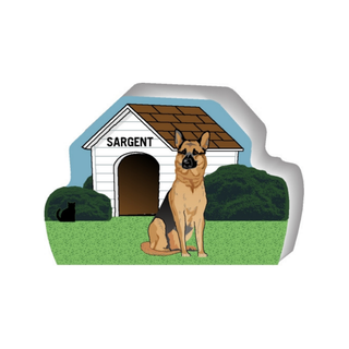 wooden replica of a illustrated brown and black german shepherd dog standing in front of a dog house