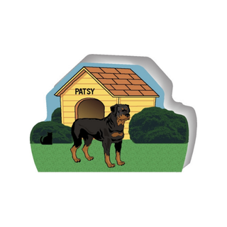 wooden replica of a illustrated black and brown dog standing in front of a dog house