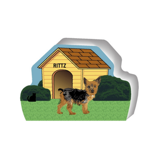 wooden replica of a little brown and black dog standing in front of a dog house