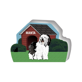 wooden replica of a illustrated white and black long haired  dog standing in front of a dog house
