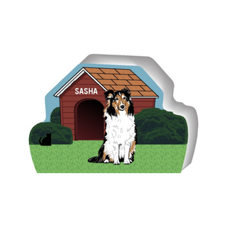 wooden replica of a illustrated white brown and black dog standing in front of a dog house