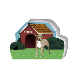 wooden replica of a illustrated white and brown pitbull dog standing in front of a dog house