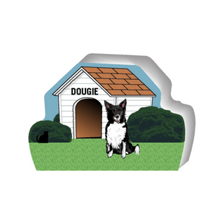 wooden replica of a illustrated black and white border collie dog standing in front of a dog house
