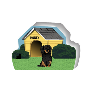 wooden replica of a illustrated black and brown longhaired dachshund dog standing in front of a dog house