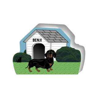 wooden replica of a illustrated black and tan dachshund dog standing in front of a dog house