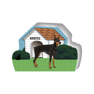 wooden replica of a illustrated black and brown dog standing in front of a dog house