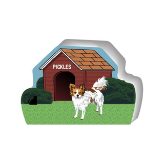 wooden replica of a illustrated white and brown little dog standing in front of a dog house