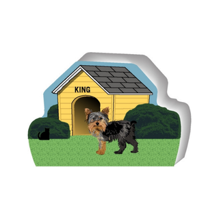 wooden replica of a illustrated brown and black dog standing in front of a dog house
