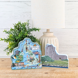 Decorative stand with a map design and a castle illustration on a wooden surface.