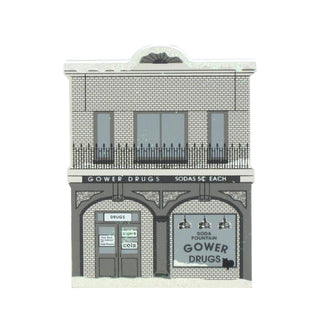3/4" thick wooden replica with an illustration of a Model of a two-story building with 'Gower Drugs' signage on a white background