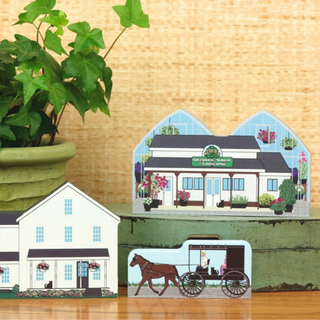 3/4" Wooden replica with a Set of amish  houses and a horse buggy on a wooden surface with a plant in the background.