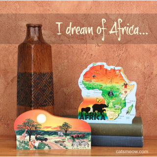 Decorative items including a map of Africa and a bottle on a wooden surface with 'I dream of Africa' text.