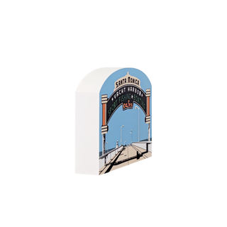 3/4" thick wooden Decorative shelf sitter with a design of a bridge and 'Santa Monica Pier' sign on a white background.