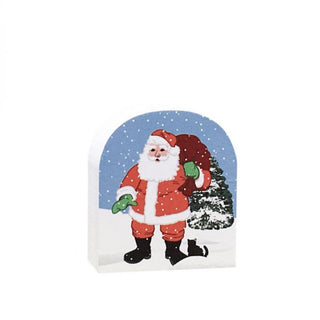 3/4" thick wooden replica with an Illustration of a Santa Claus in a snowy scene, with a blue sky, white snow, red suit, green gloves, and a dark green tree on a plain white background.
