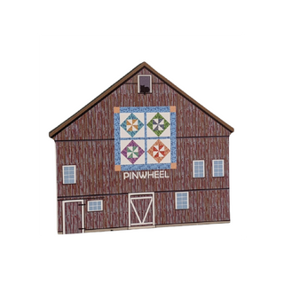 3/4" thick wooden illustration of a brown barn with a quilt