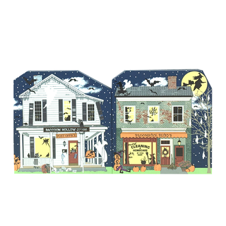 Illustration of two 3/4" thick wooden Halloween-themed houses with decorated windows and signs.