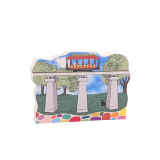 3/4" thick wooden cutout Colorful illustration of a trolley on tracks with trees and a blue sky.