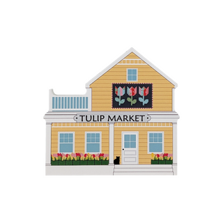 3/4" thick wooden illustration of a yellow building with a tulip quilt