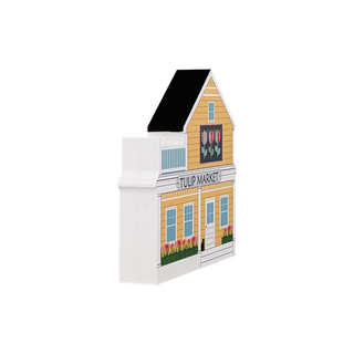 3/4" thick wooden illustration of a yellow building with a tulip quilt