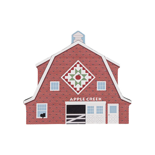 3/4" thick wooden illustration of a red barn with a quilt block