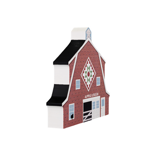 3/4" thick wooden illustration of a red barn with a quilt block