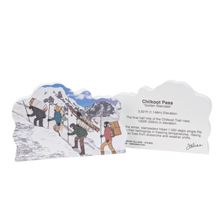  wooden replica with an illustration with  people hiking and text about Chilkoot Pass and the back of product with black text about chilkoot pass