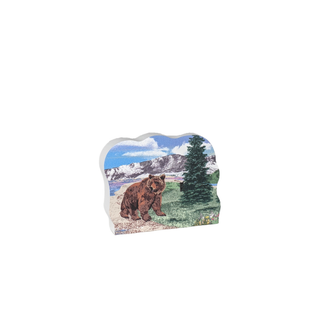 3/4" wooden replica with an illustration of a bear in a natural landscape with mountains and trees.