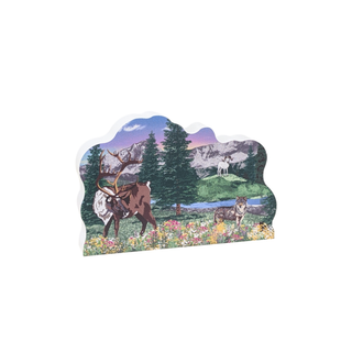 decorative wooden replica with an illustration of a mountain landscape with animals 