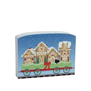 3/4" thick wooden replica with an illustration of a gingerbread house train car design on a blue background