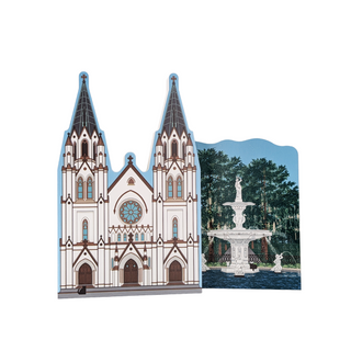 3/4" wooden replica with an illustration of a cathedral with two spires and a fountain in the background on a white background.