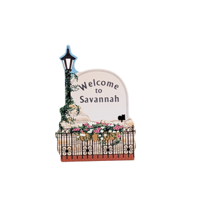 Decorative sign with 'Welcome to Savannah' text on a white background