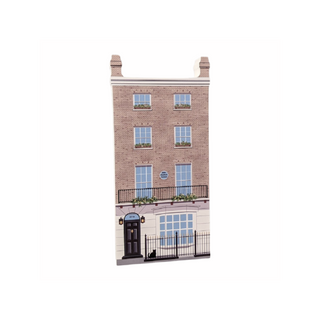 3/4" thick wooden cutout of  a brick building with windows and a door on a white background