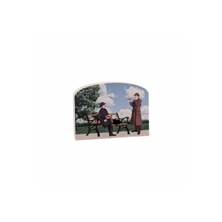 3/4" thick wooden cutout of two people on a bench with trees and sky in the background