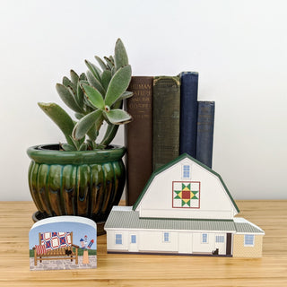 3/4" thick wooden illustration of a white barn and bench on display