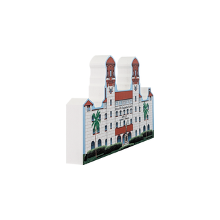 3/4" thick wooden illustration of a building with palm trees on a white background