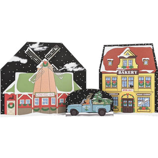 Set of Christmas-themed wooden replica buildings with a truck in front on a white background