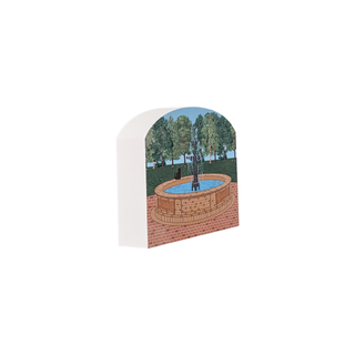 3/4" wooden replica with an illustration of a brick fountain and trees design on a white background